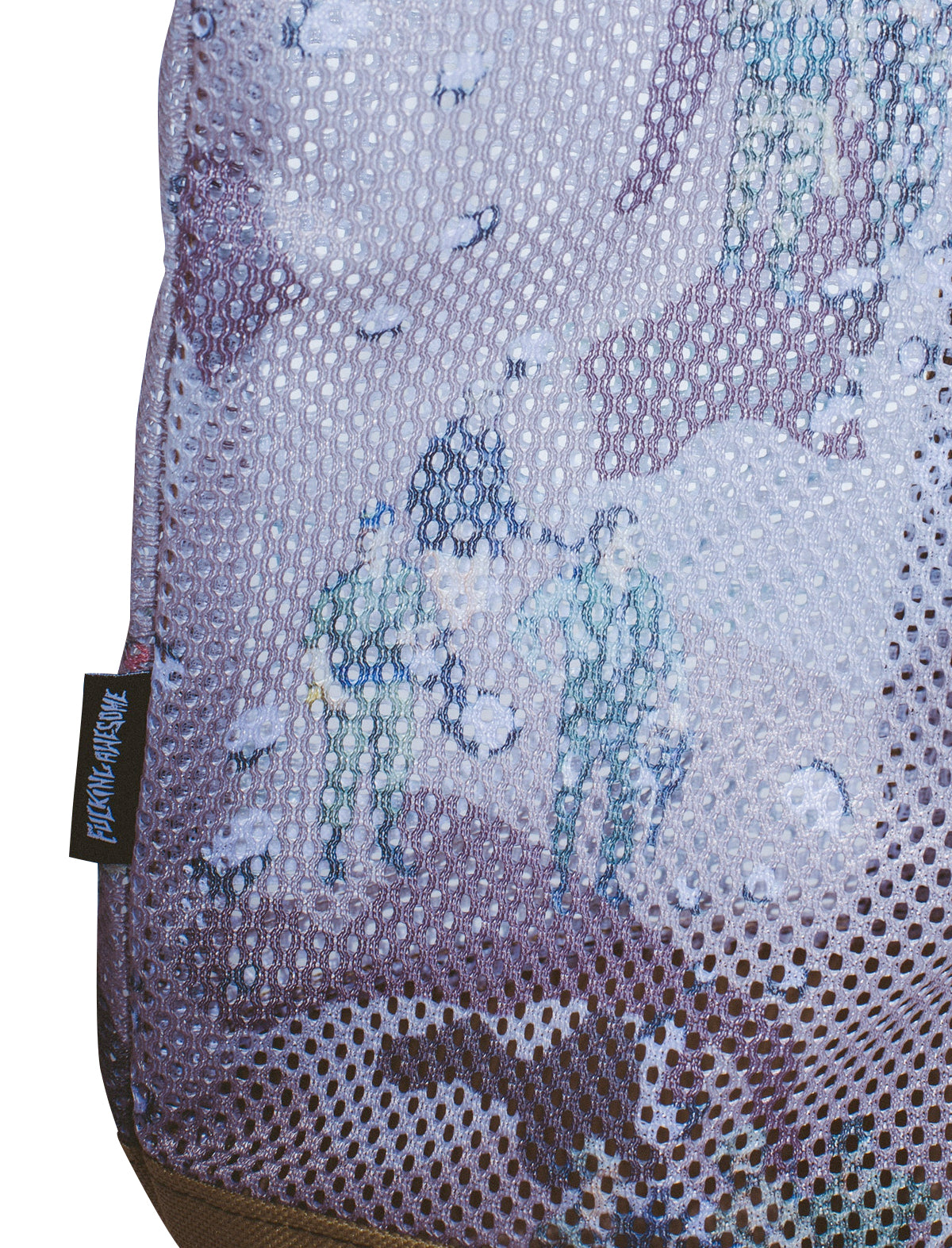 Close-up of a textured fabric with a pattern and a brand label.