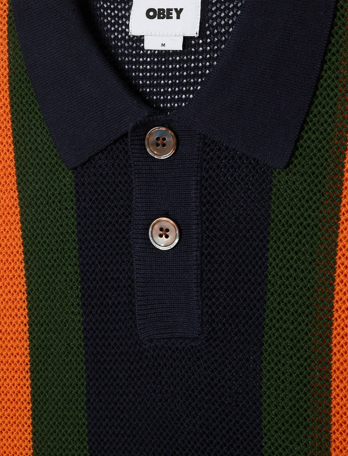 Navy polo shirt with buttons on a striped background