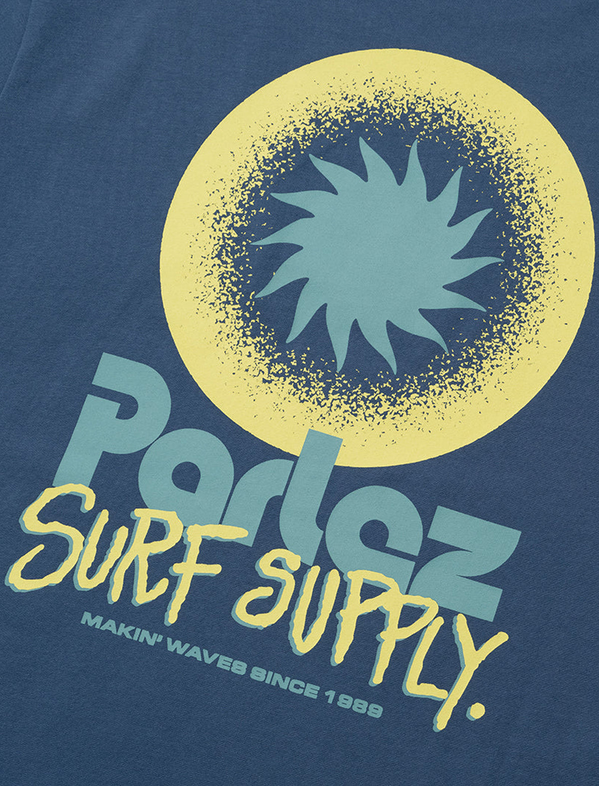 T-shirt with 'Parlez Surf Supply' logo on a blue background