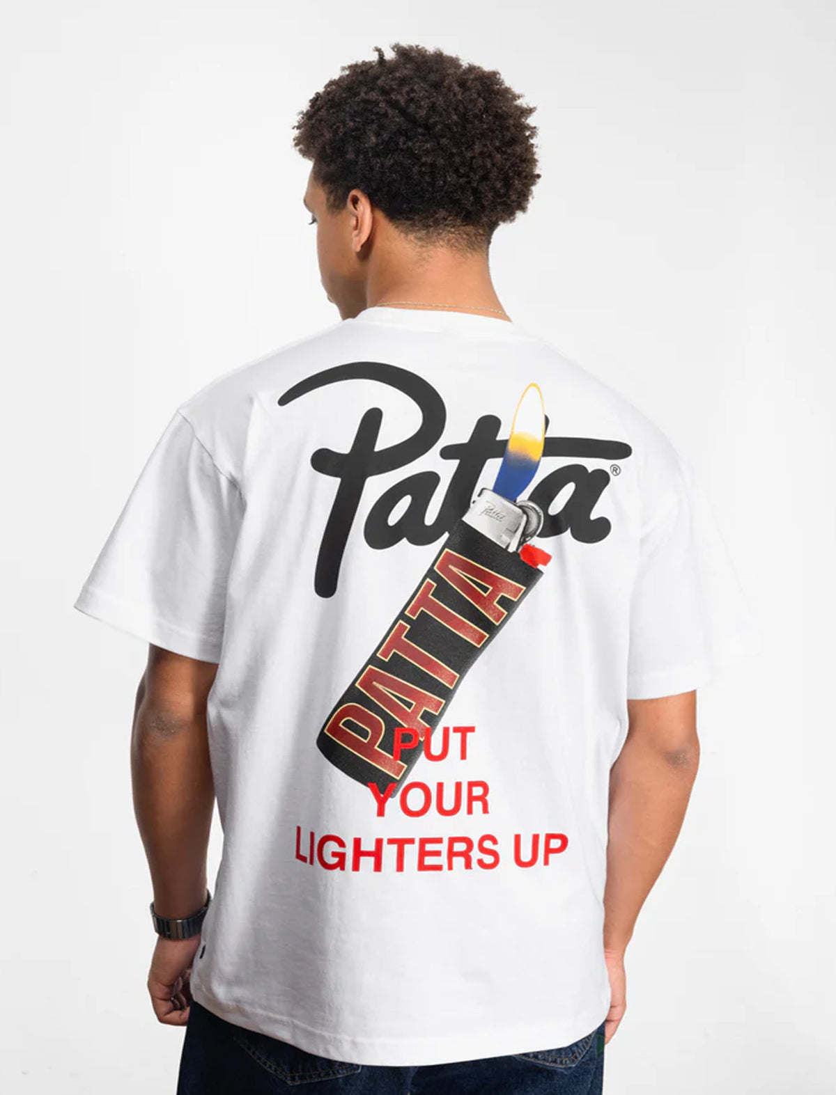 Person wearing a white t-shirt with 'Patta' branding and text on the back.