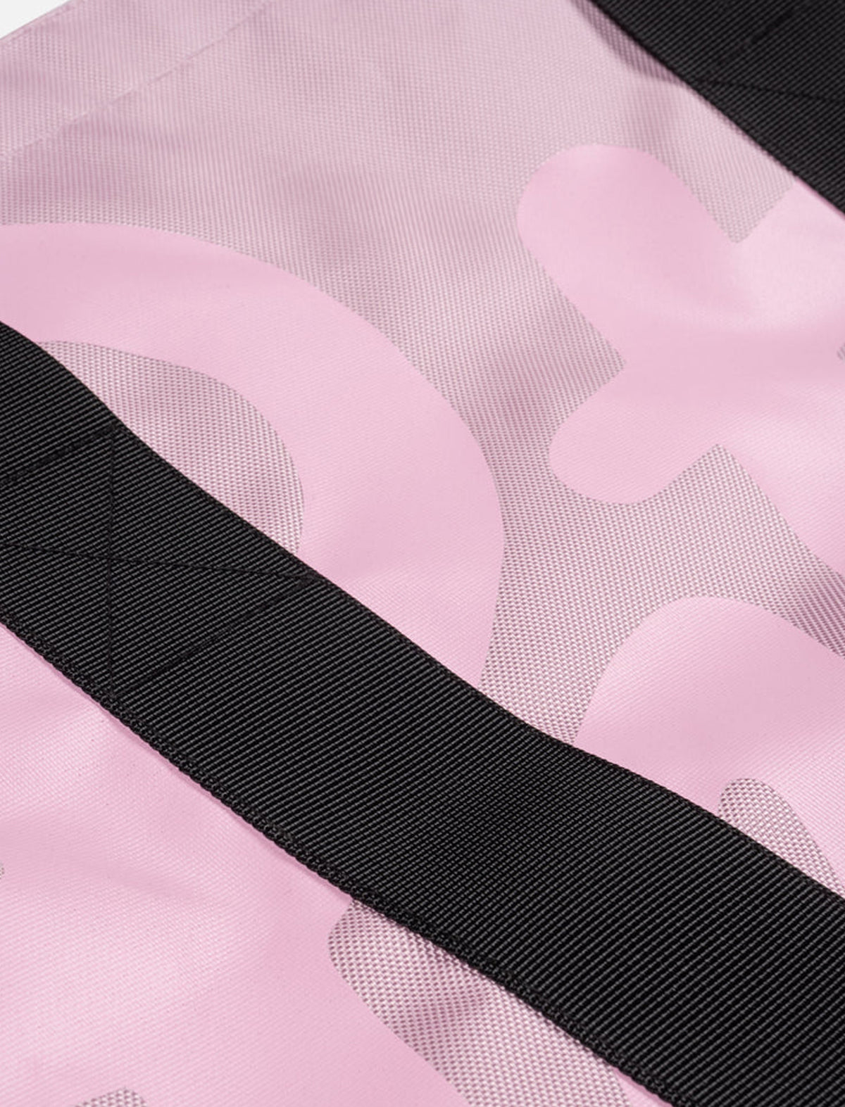 Close-up of a pink Patta bag with a black strap.