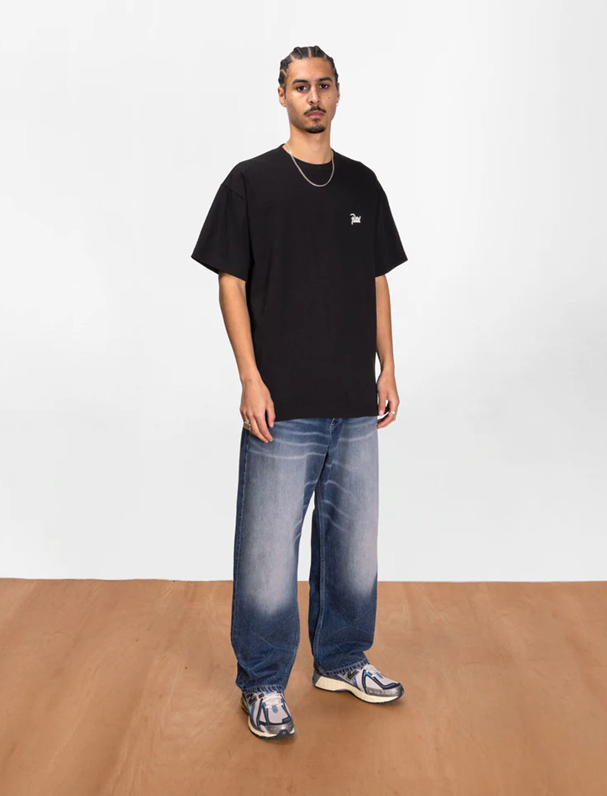Patta Black T-Shirt being worn by a man on a white background