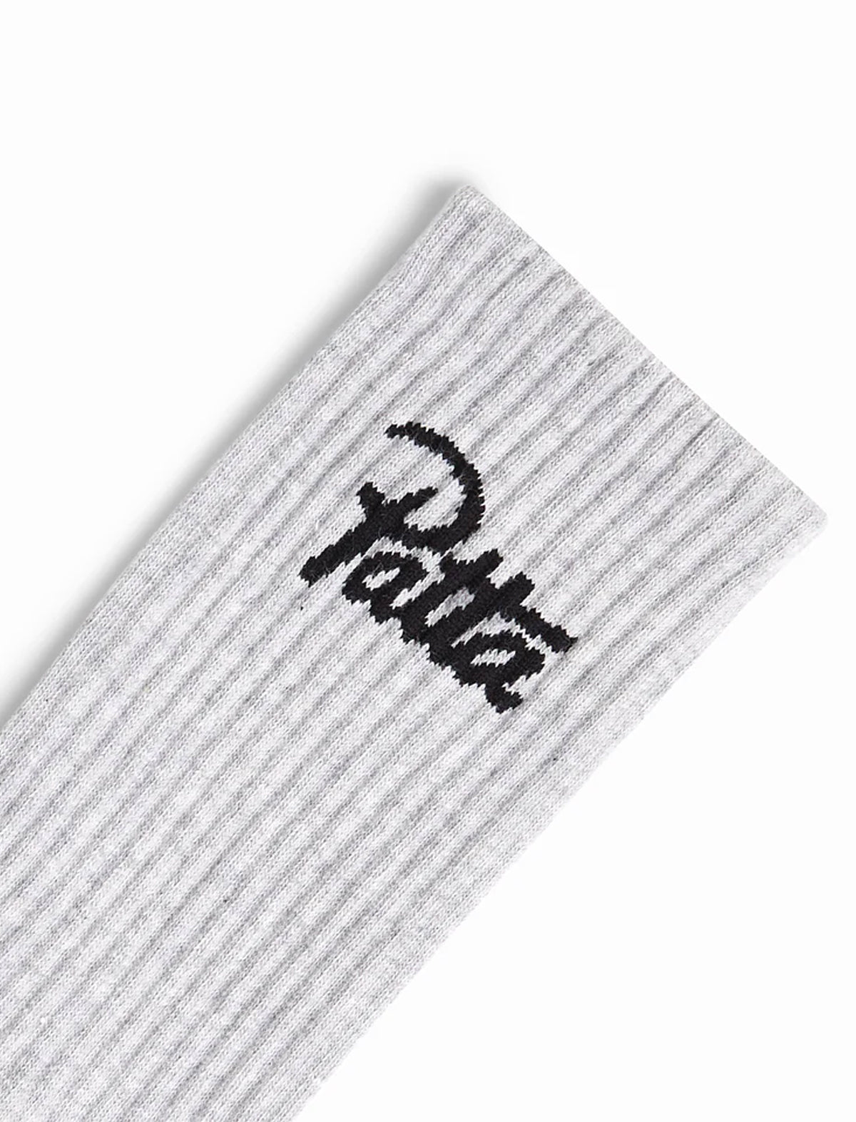 Gray sock with black Patta logo on a white background