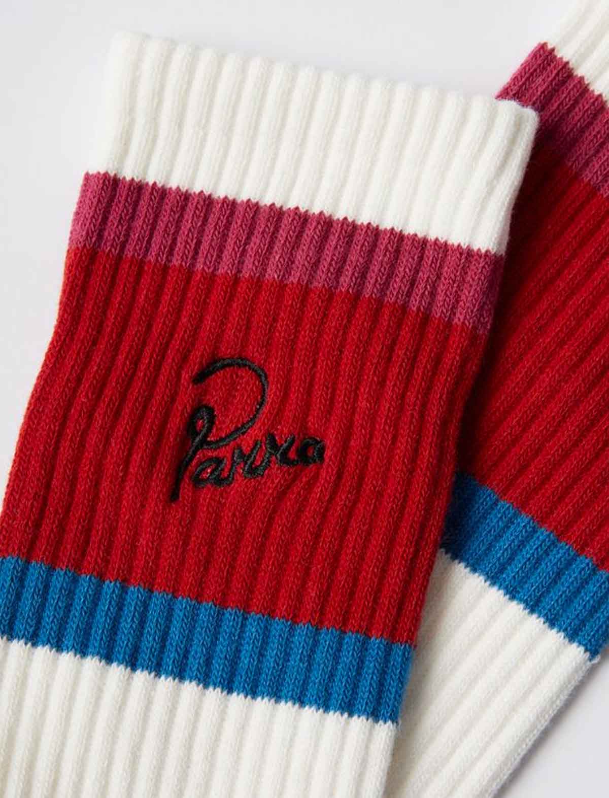 Colorful ribbed knit socks with a brand By Parra logo on a light background