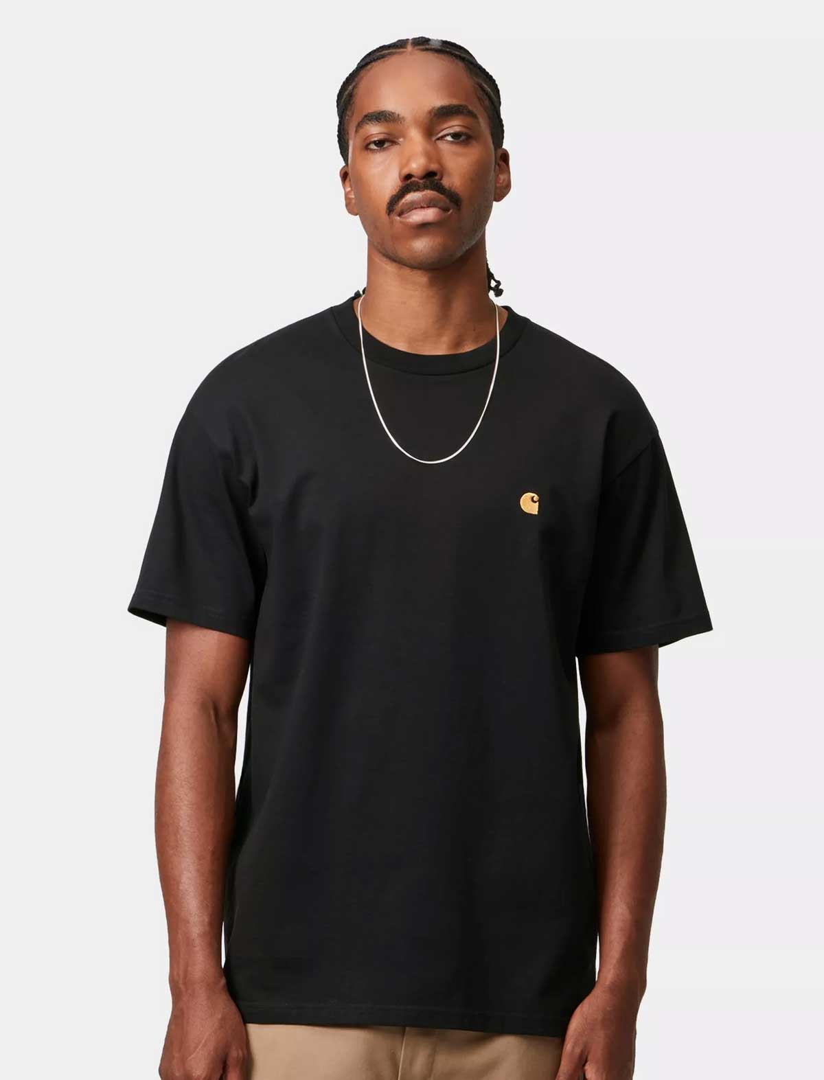Man wearing a Carhartt WIP S/S Chase black t-shirt with a small logo on a white background