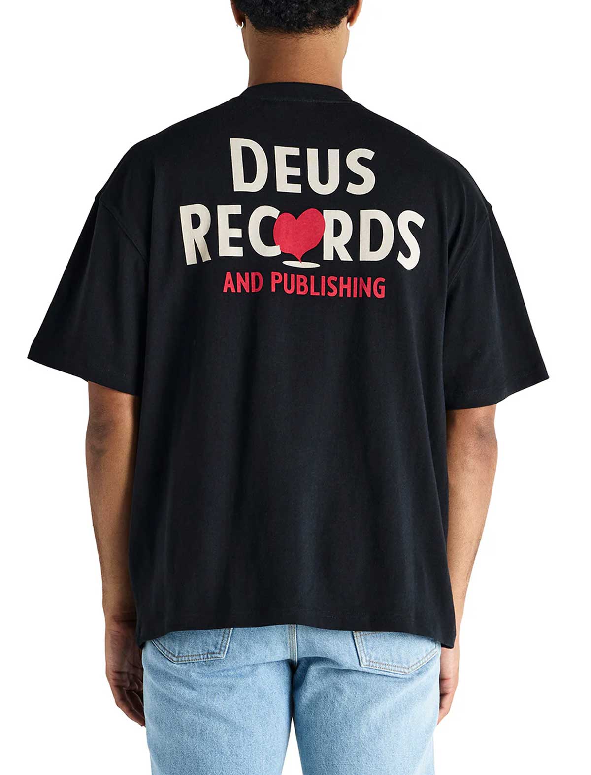 Person wearing a deus ex machina deep cut black t-shirt with 'Deus Records and Publishing' text on the back.