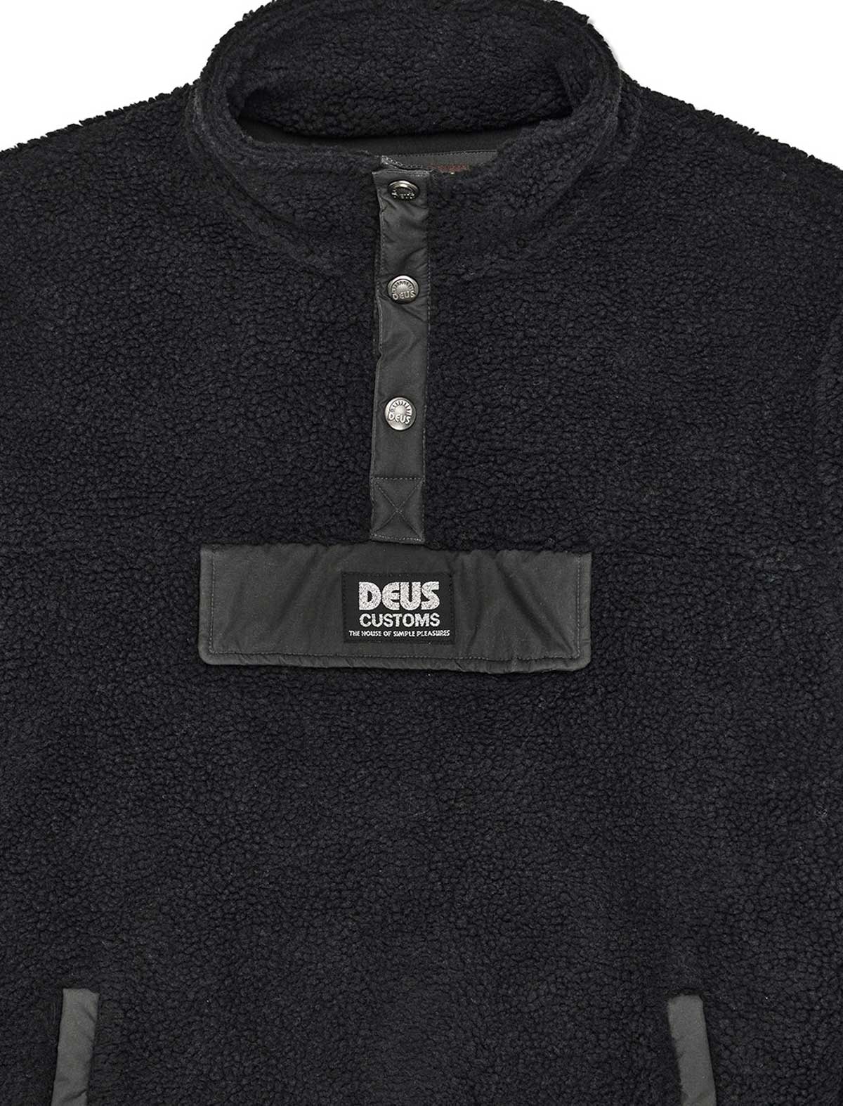 Black fleece pullover with a visible brand label on a white background