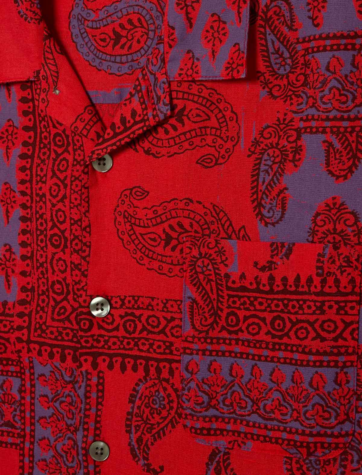 Red fabric with black paisley patterns