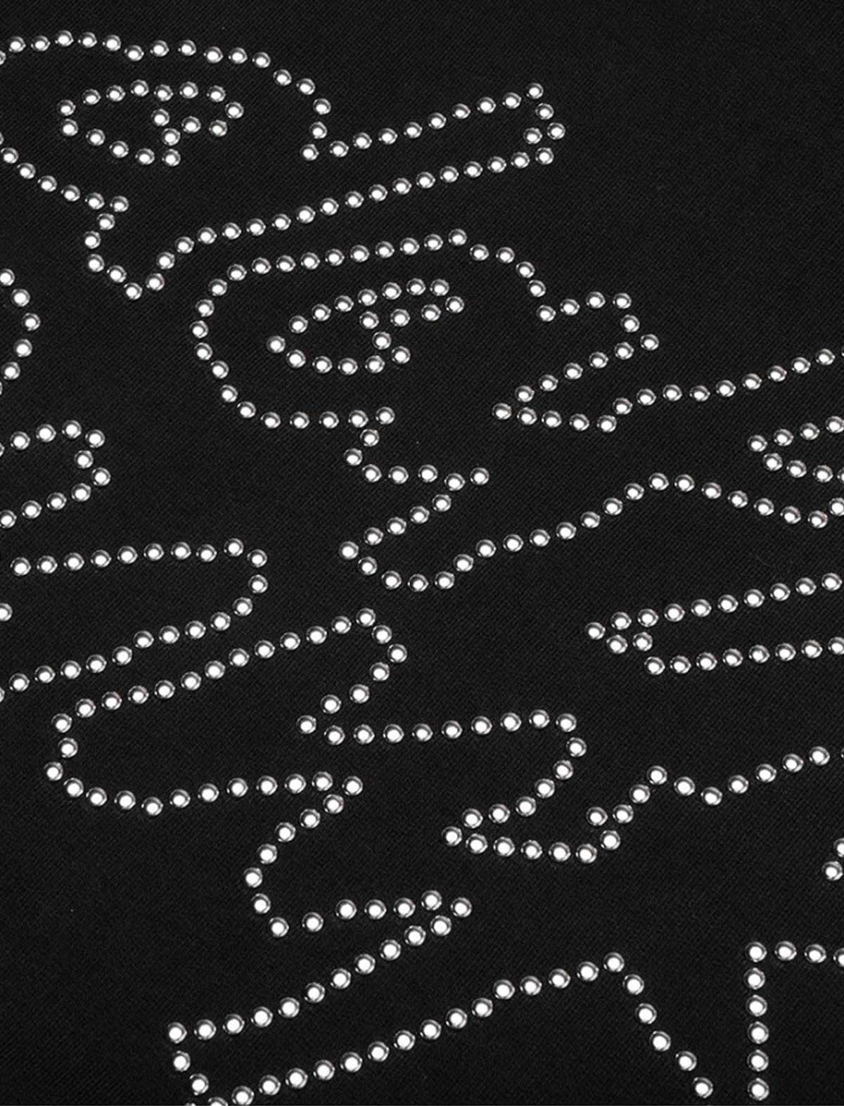 Black fabric with white rhinestone patterns on a black background