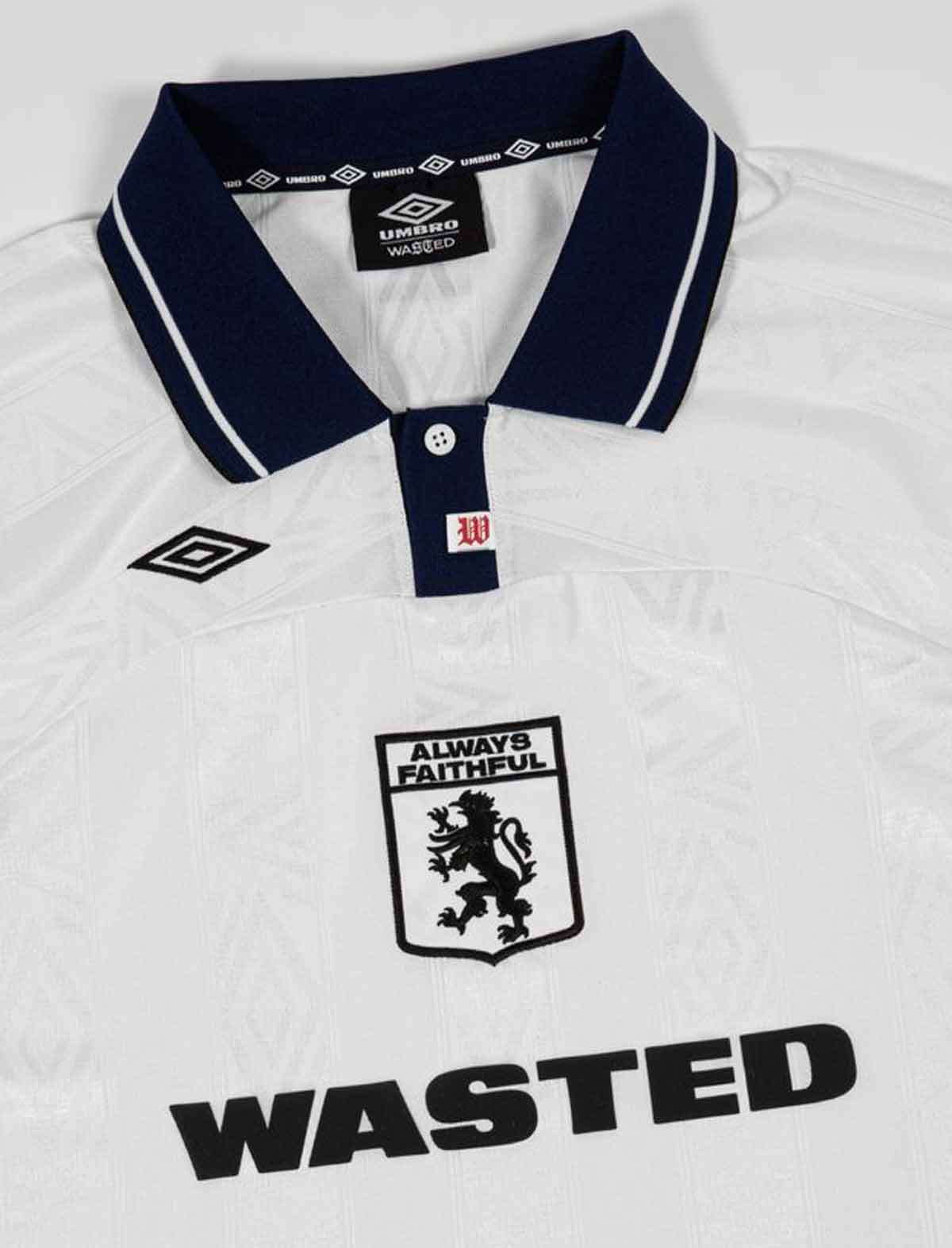 Wasted Paris x Umbro Football White polo shirt with navy collar and text, featuring an Umbro logo.
