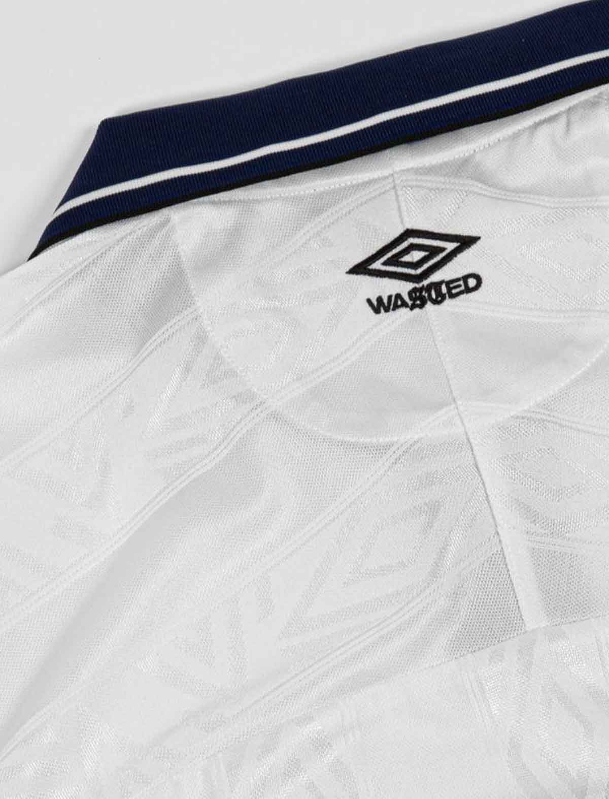 Wasted Paris x Umbro Football White sports jersey with a navy collar and black logo on a light gray background