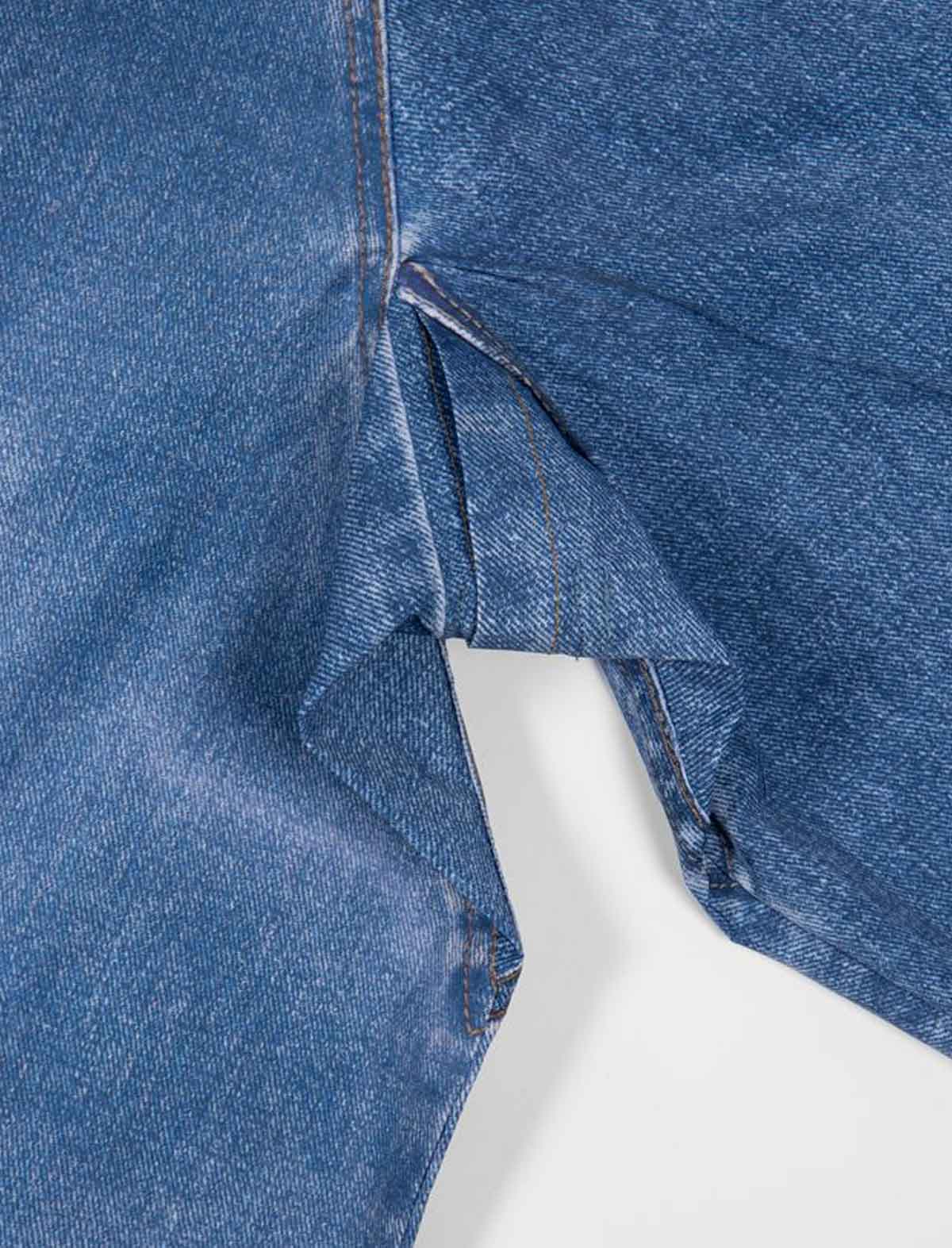 Close-up of Wasted Paris x Umbro Trompe L'Oel Windbreaker blue denim fabric with a white background