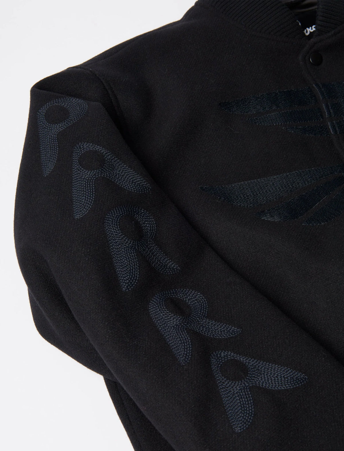 Black hoodie with embroidered logo on a white background