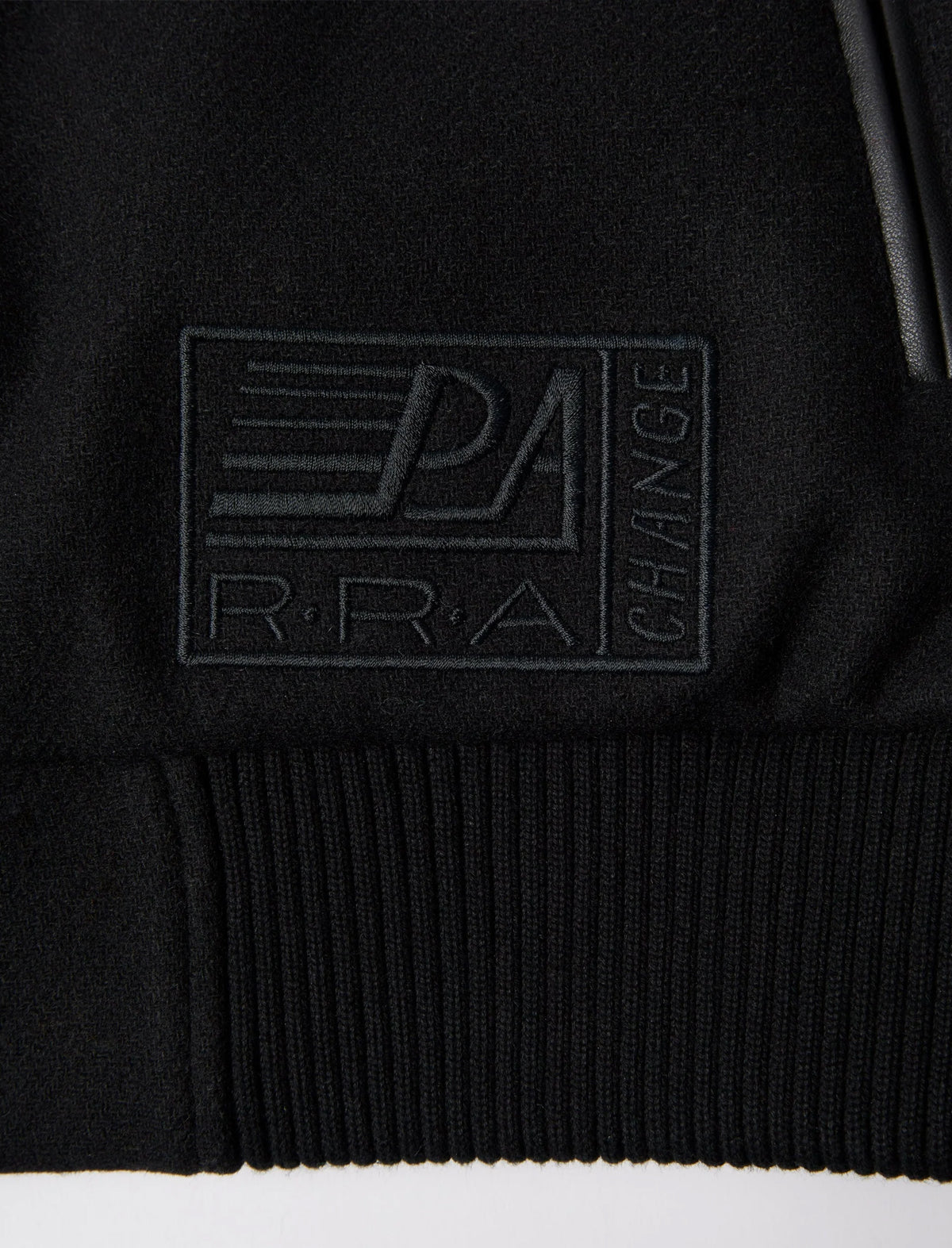 Black jacket with a logo on the chest