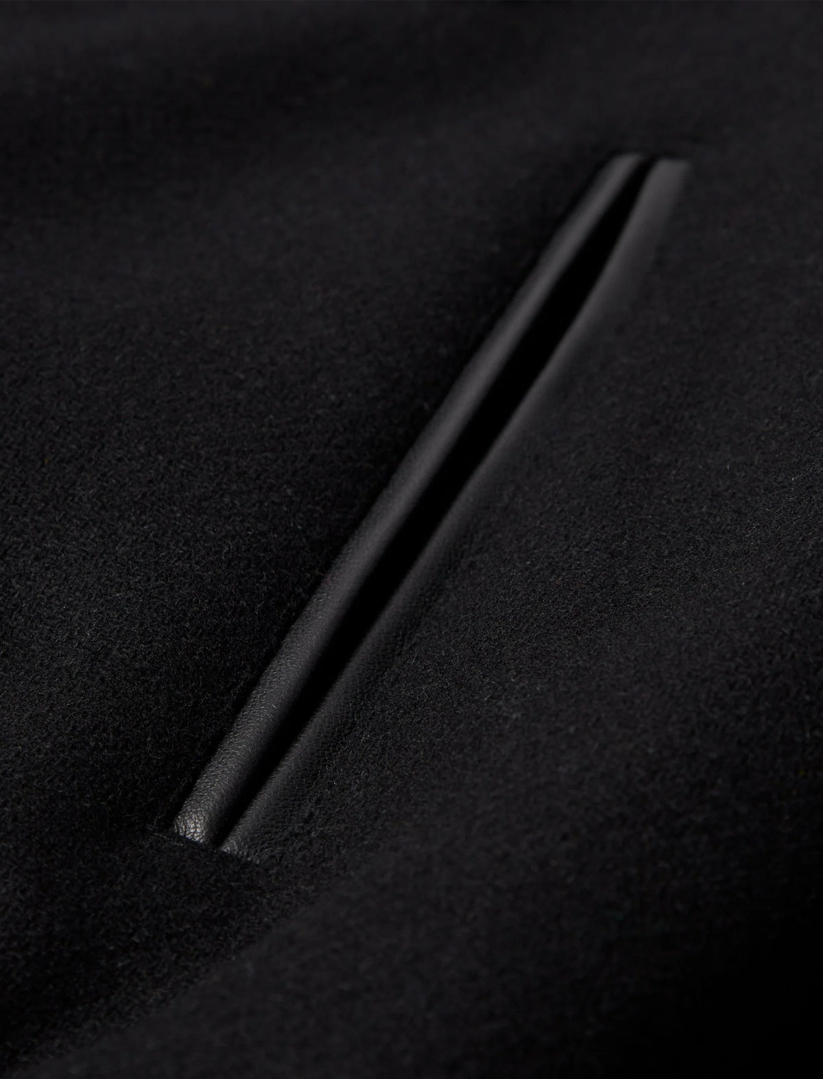 Black metal rod on a textured black surface