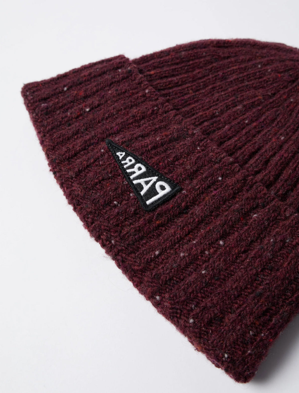 Maroon knit beanie with a logo on a light gray background