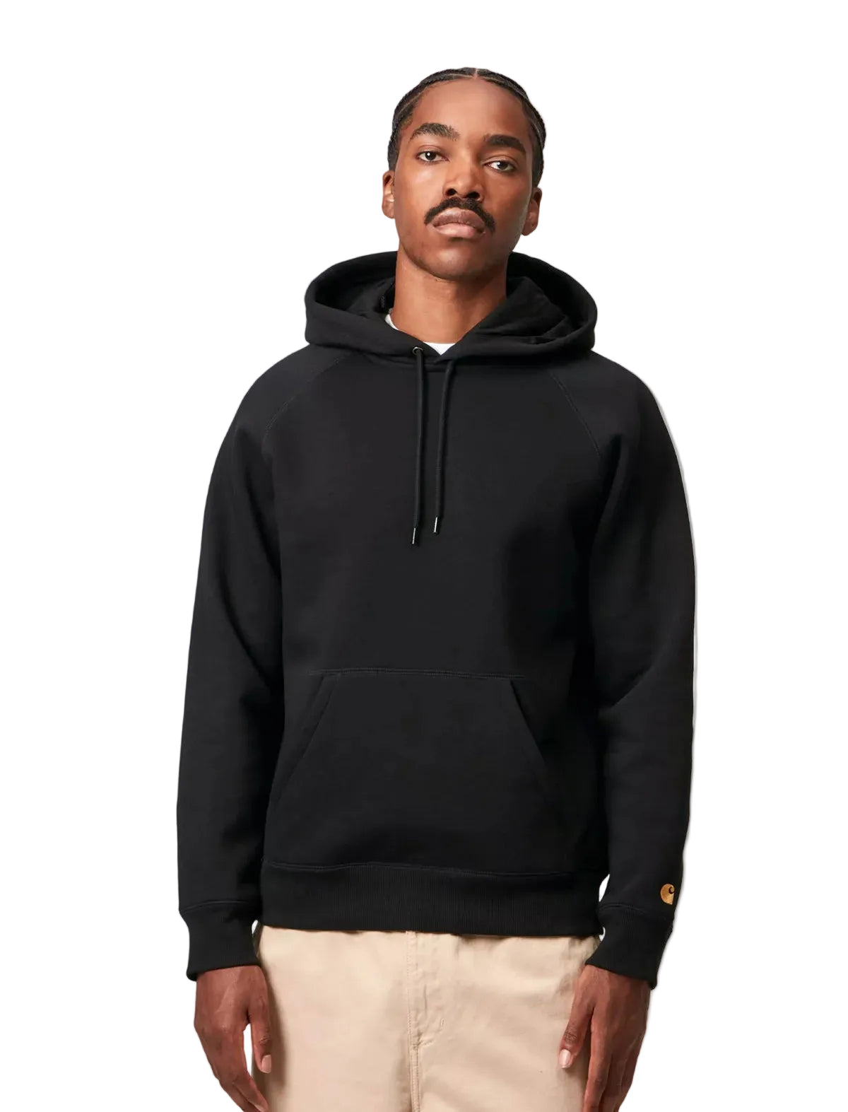 Man wearing a black Carhartt hoodie on a white background