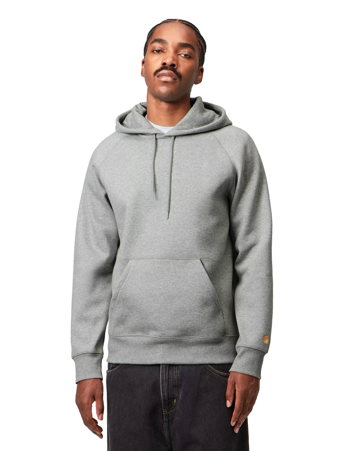 Man wearing a Carhartt gray hoodie on a white background