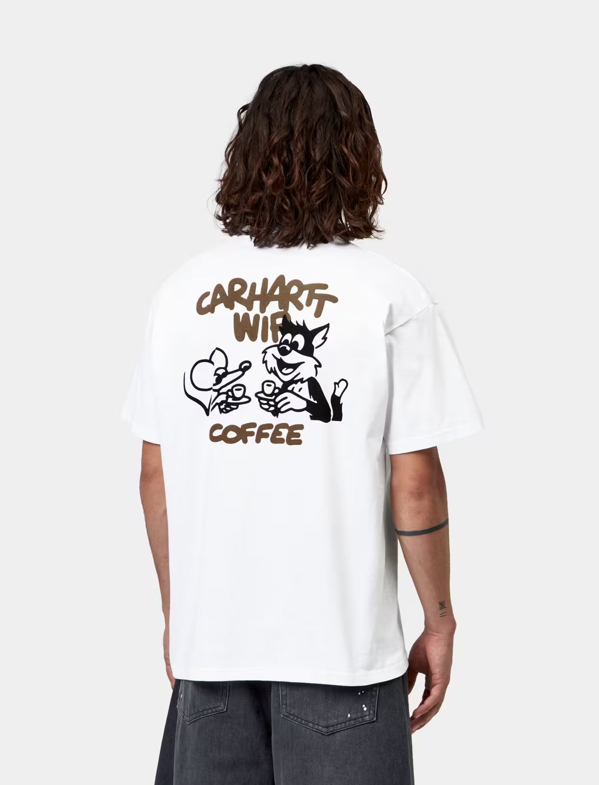 Person wearing a white t-shirt with a graphic and text on the back, standing against a plain background.