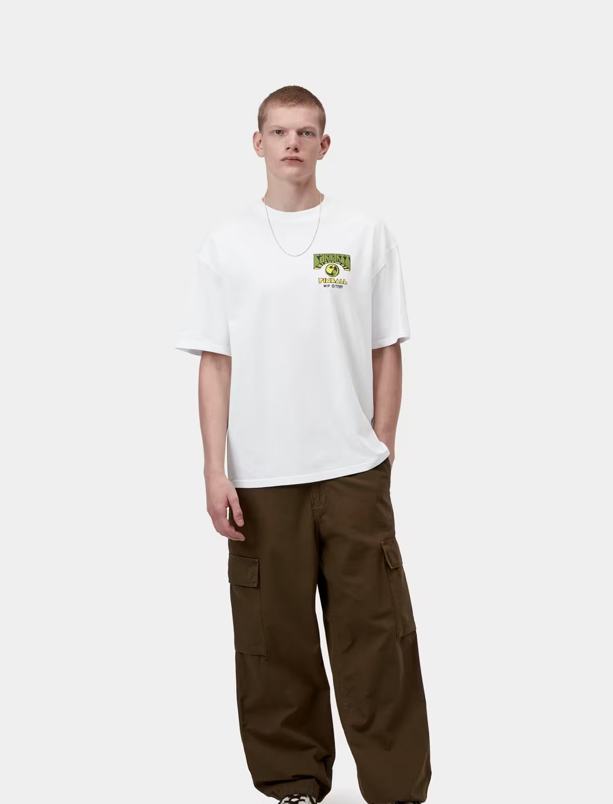 Person wearing a white t-shirt with a logo and brown cargo pants on a white background