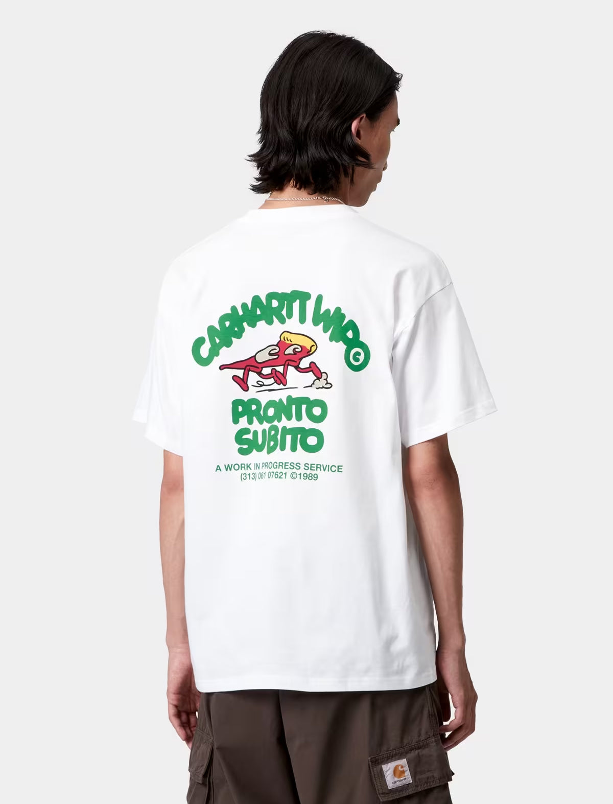 Person wearing a carhartt wip pronto white t-shirt with a colorful graphic and text on the back.