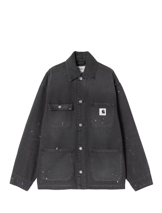 A dark gray Carhartt canvas utility jacket with silver paint splatter details, featuring a pointed collar, button-up front, and a white Carhartt logo patch on the left chest pocket, displayed against a solid white background.