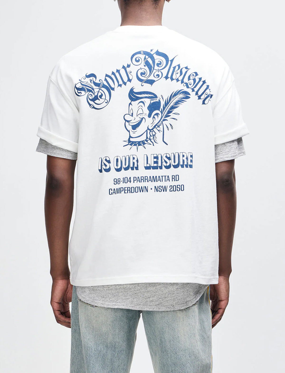 Person wearing a white t-shirt with blue graphics and text on the back.