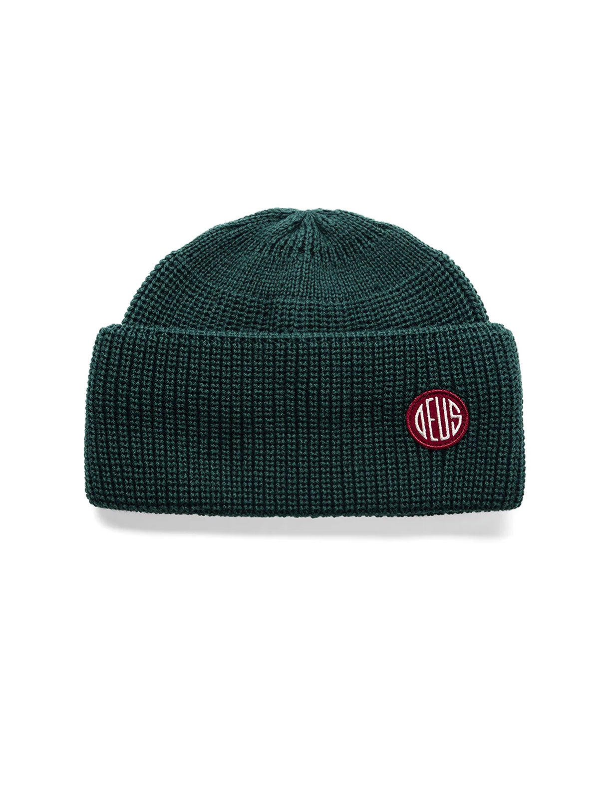 A dark green ribbed knit beanie hat with a small circular red and white embroidered logo patch on the front cuff, shown against a plain white background.