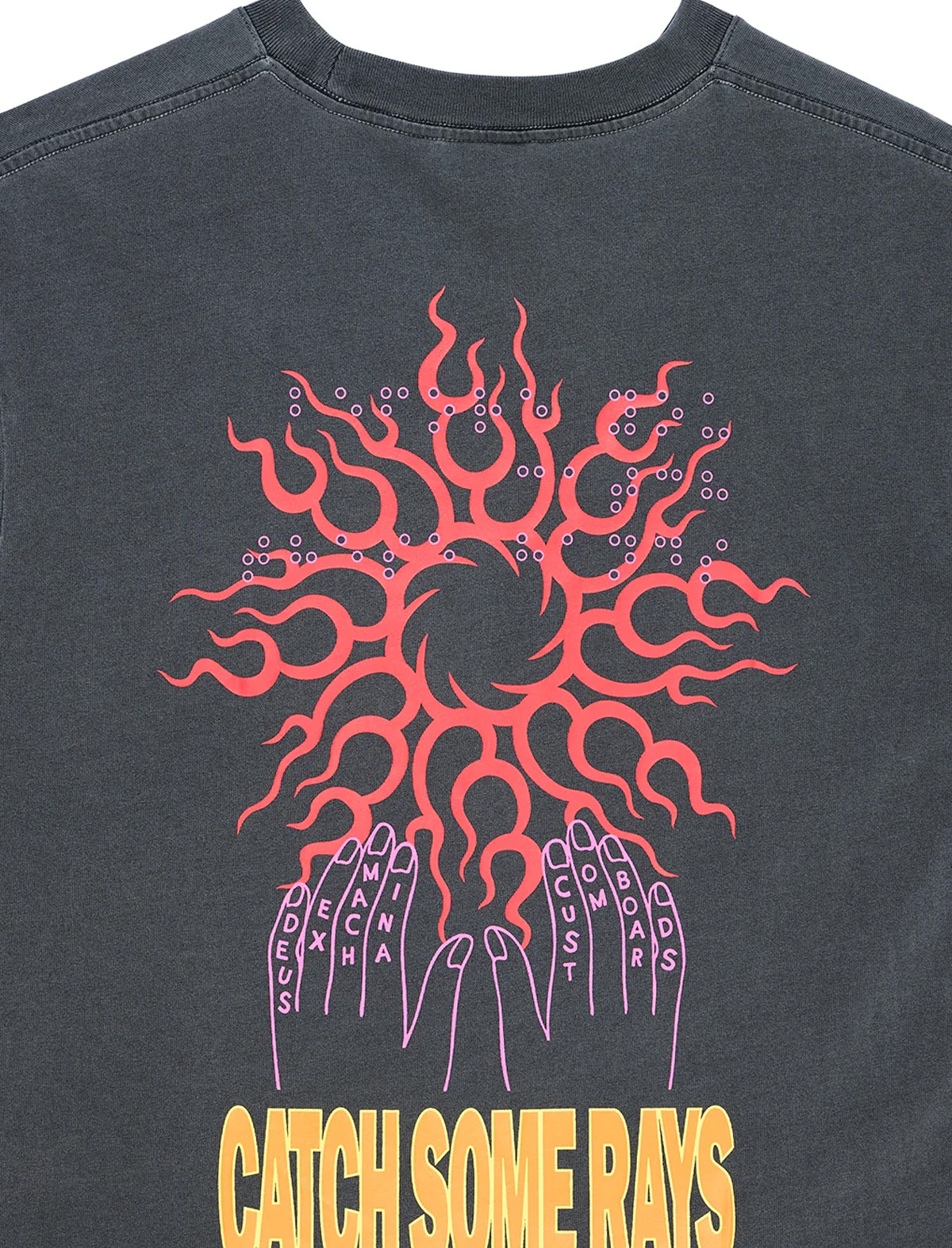 Close-up of the back of a dark charcoal gray t-shirt featuring a graphic print of a red sunburst and purple hands with the text 'CATCH SOME RAYS' in yellow at the bottom.