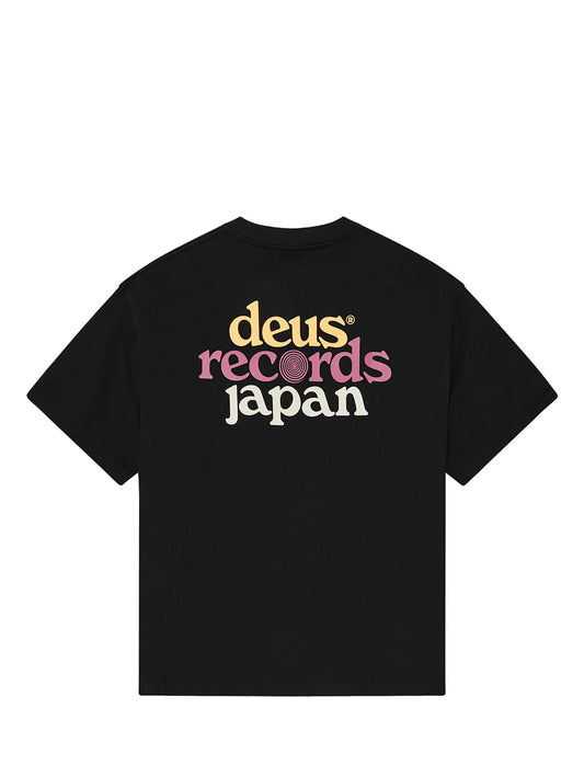 A black short-sleeve t-shirt with a retro graphic print on the chest reading 'deus records japan' in yellow, pink, and white lettering, shown against a plain white background.