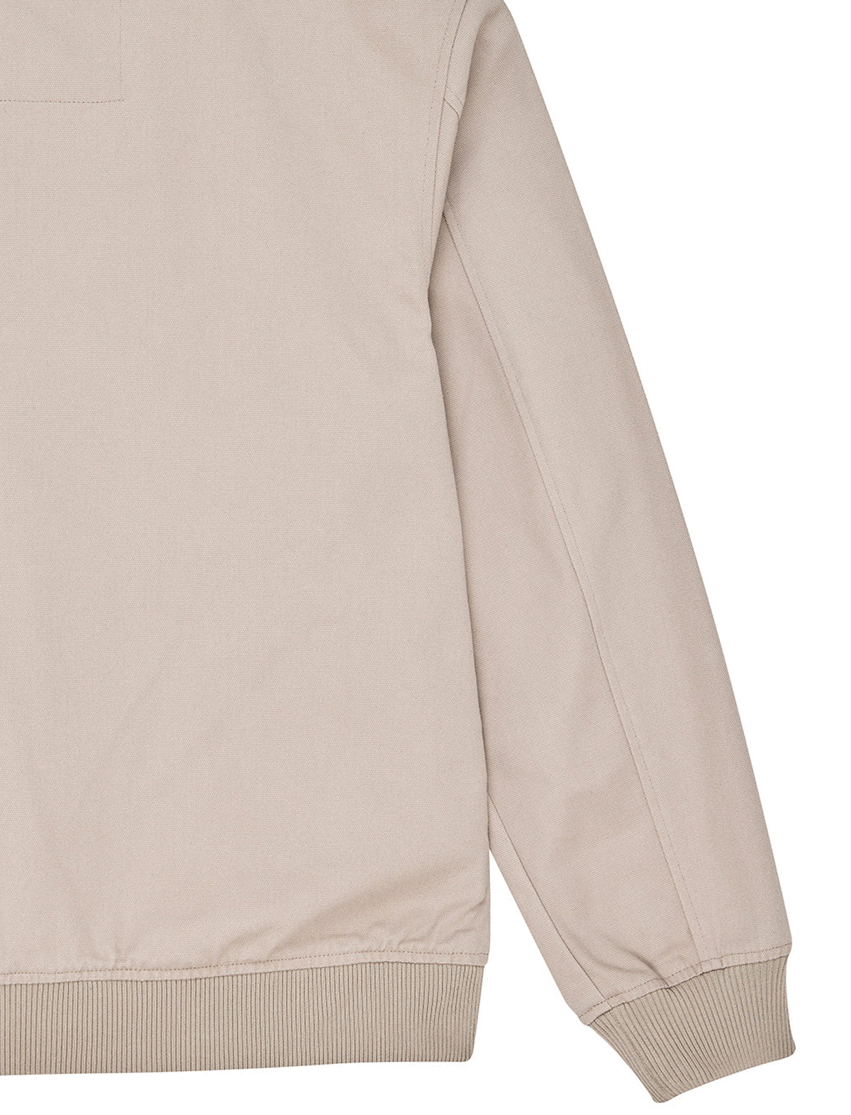 Close-up of a light beige jacket sleeve with ribbed cuffs and hem, shown against a plain white background.