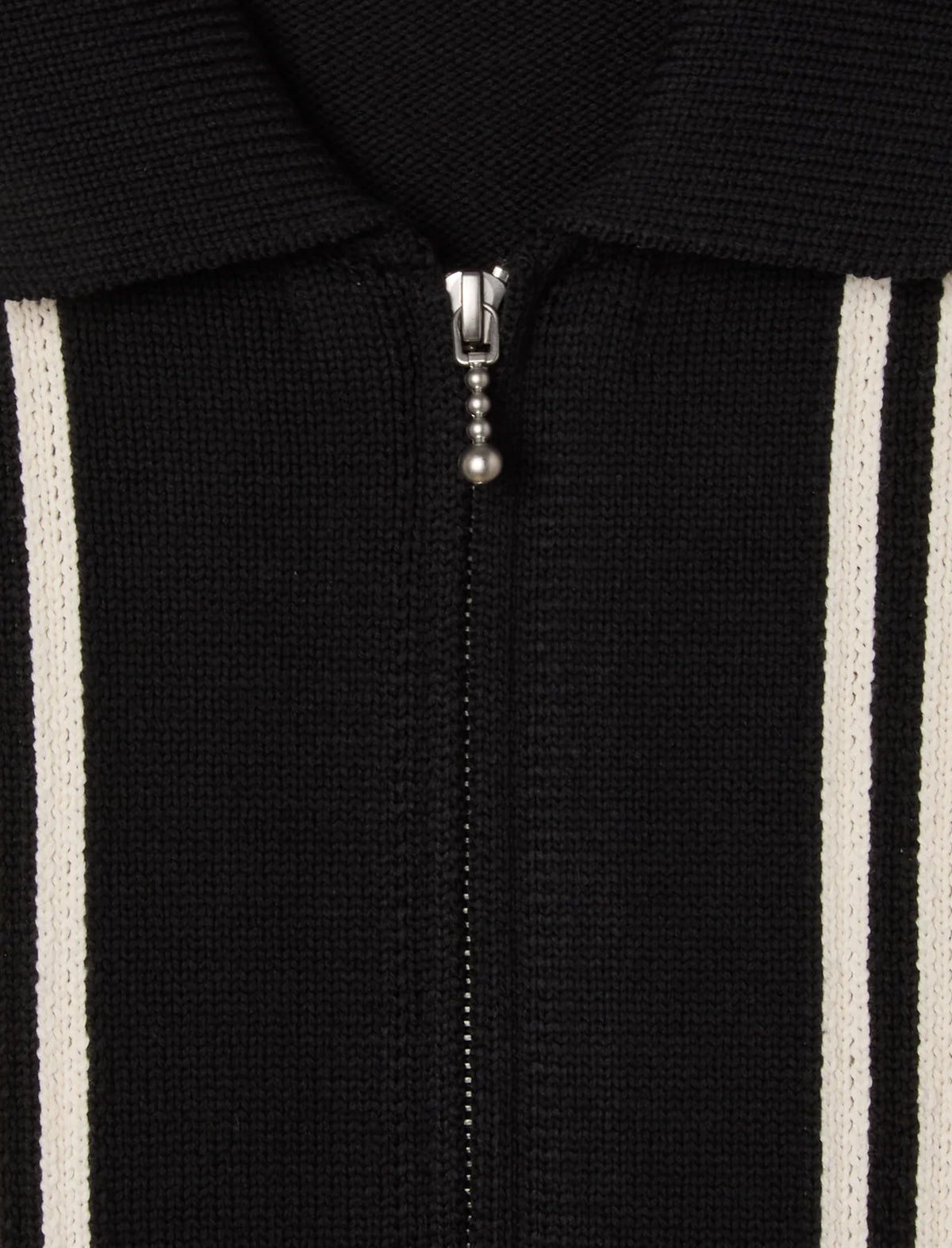Close-up of a black zip-up hoodie with white stripes on the sleeves.