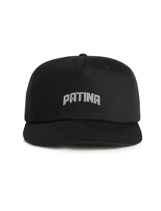 A black structured baseball cap with 'PATINA' embroidered in silver arched letters on the front, shown against a plain white background.