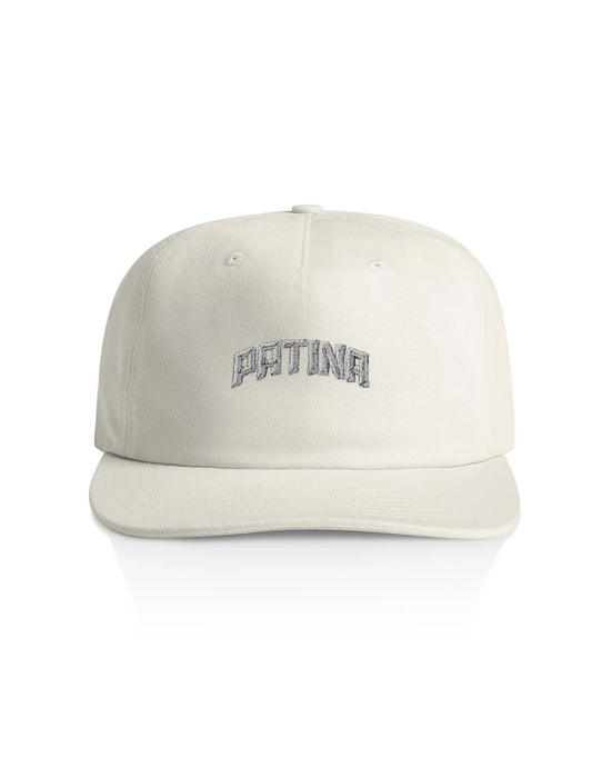 An off-white structured baseball cap with 'PATINA' embroidered in gray arched lettering on the front, shown against a plain white background.