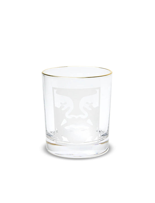 Obey Bold Logo Drinking Glass in Clear, a gold-rimmed tumbler with a frosted white Obey Icon face print