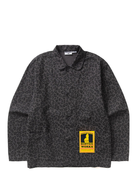 A dark gray and black leopard print button-up shirt jacket with a collar, featuring a yellow 'Service Works' patch on the lower front, displayed flat against a white background.