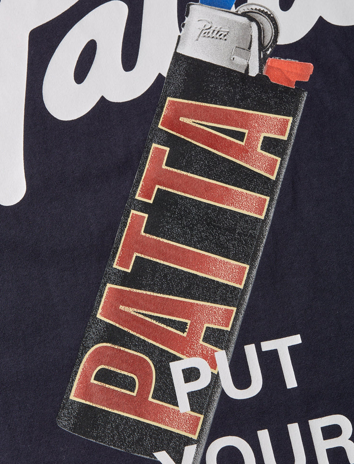 Lighter with 'Patta' branding on a dark background