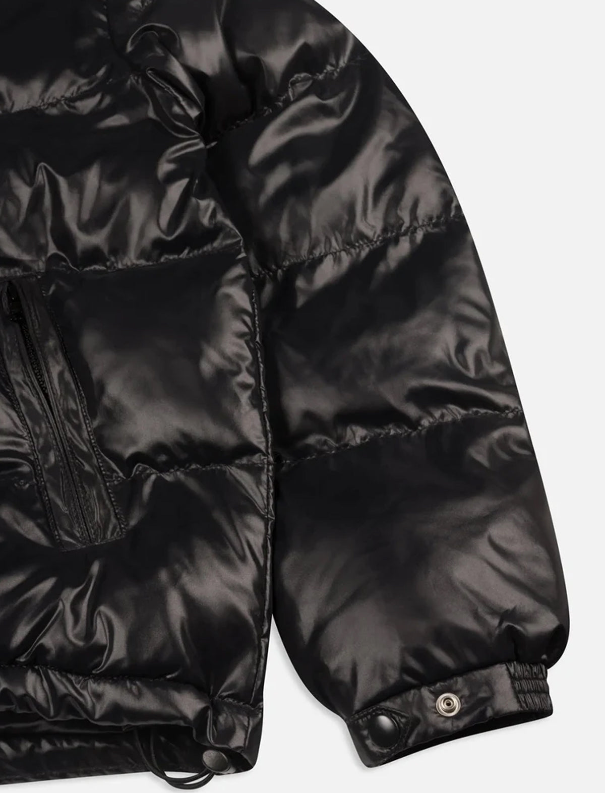 Close-up of a black puffer jacket on a light gray background