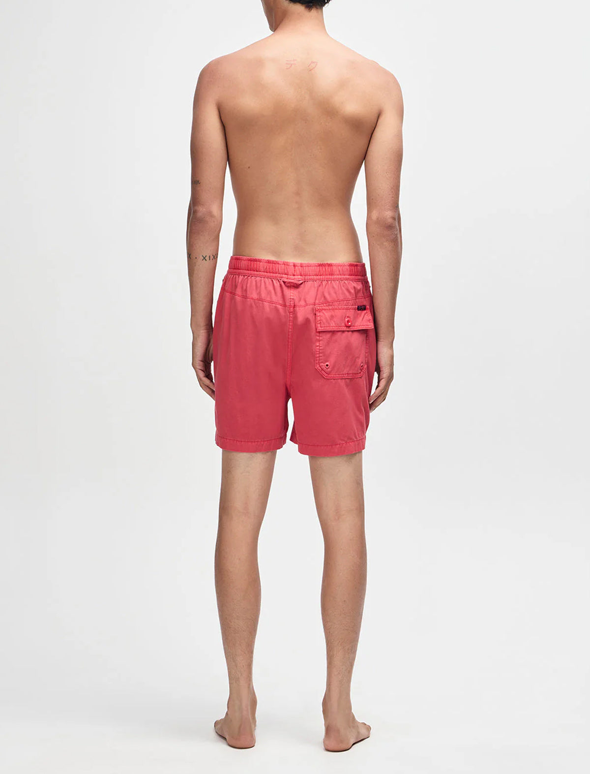 Person wearing pink shorts on a white background