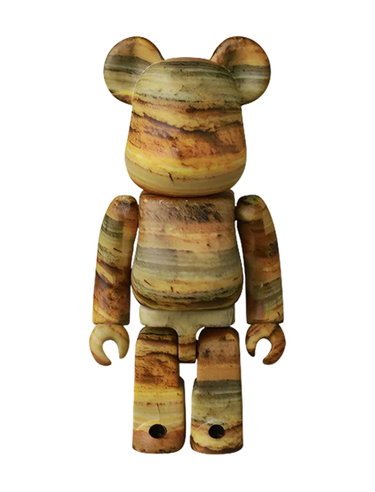 A bear-shaped collectible figure with a petrified wood grain pattern in shades of brown, beige, and yellow, isolated on a white background.