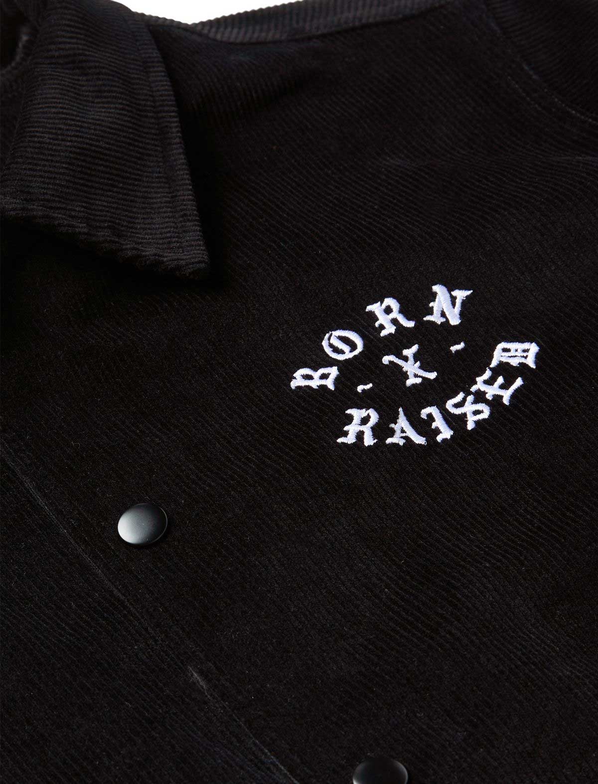 Black jacket with white embroidered text on a dark background