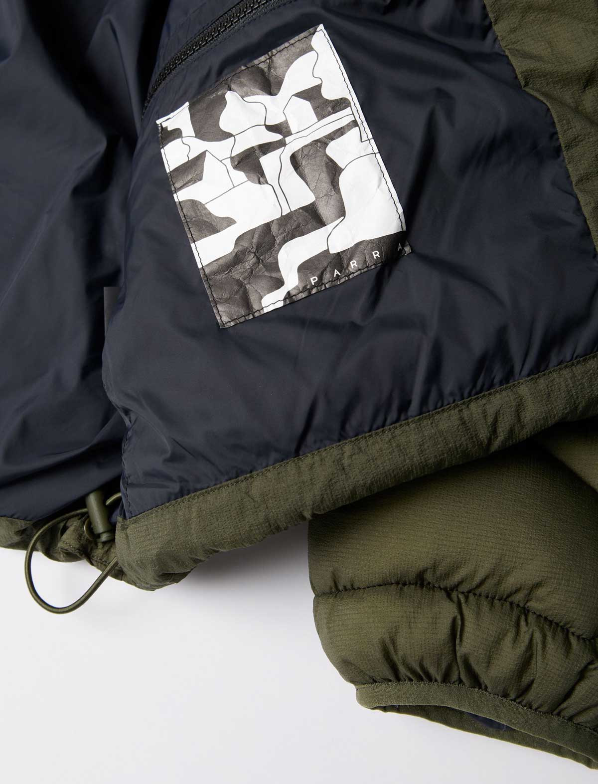 By Parra Boring Village Puffer Jacket Green lining label detail