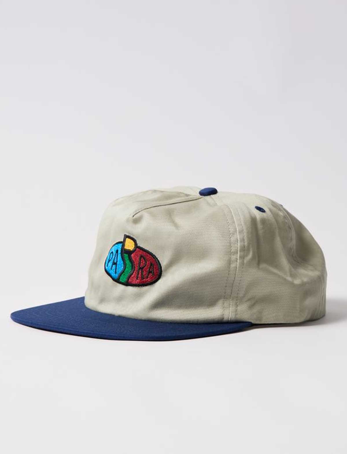 By Parra Legs Logo Beige cap with blue brim and colorful logo on a white background