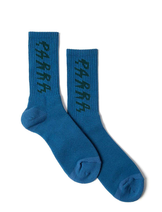 A pair of medium blue crew socks with the word 'PARRA' embroidered vertically in black on the ribbed cuffs, displayed against a plain white background.