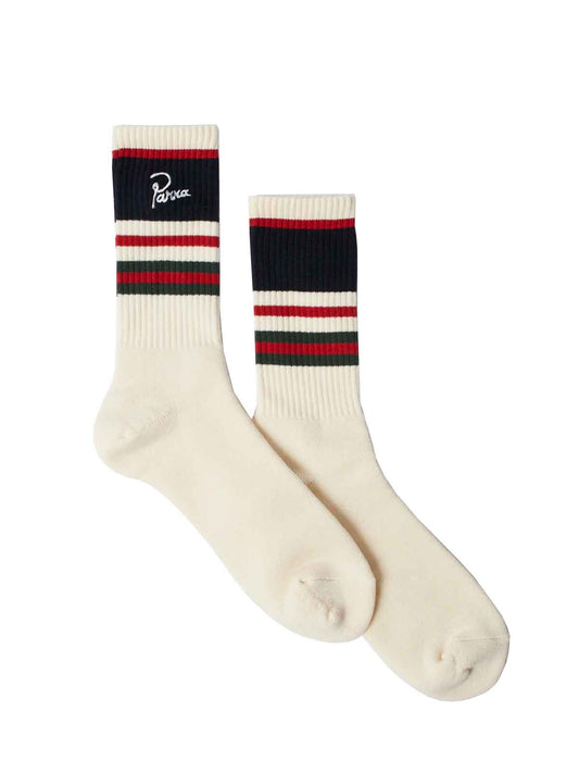 A pair of off-white crew socks with navy, red, and green stripes near the cuff. One sock features a white script logo reading 'Parra' on a navy band, while the other has a matching navy, red, and green stripe pattern.