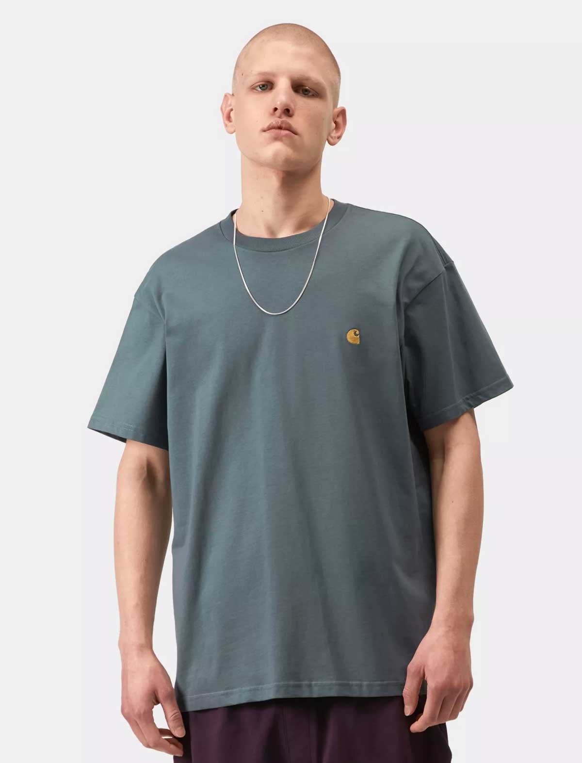 Person wearing a gray t-shirt with a brand logo on a white background