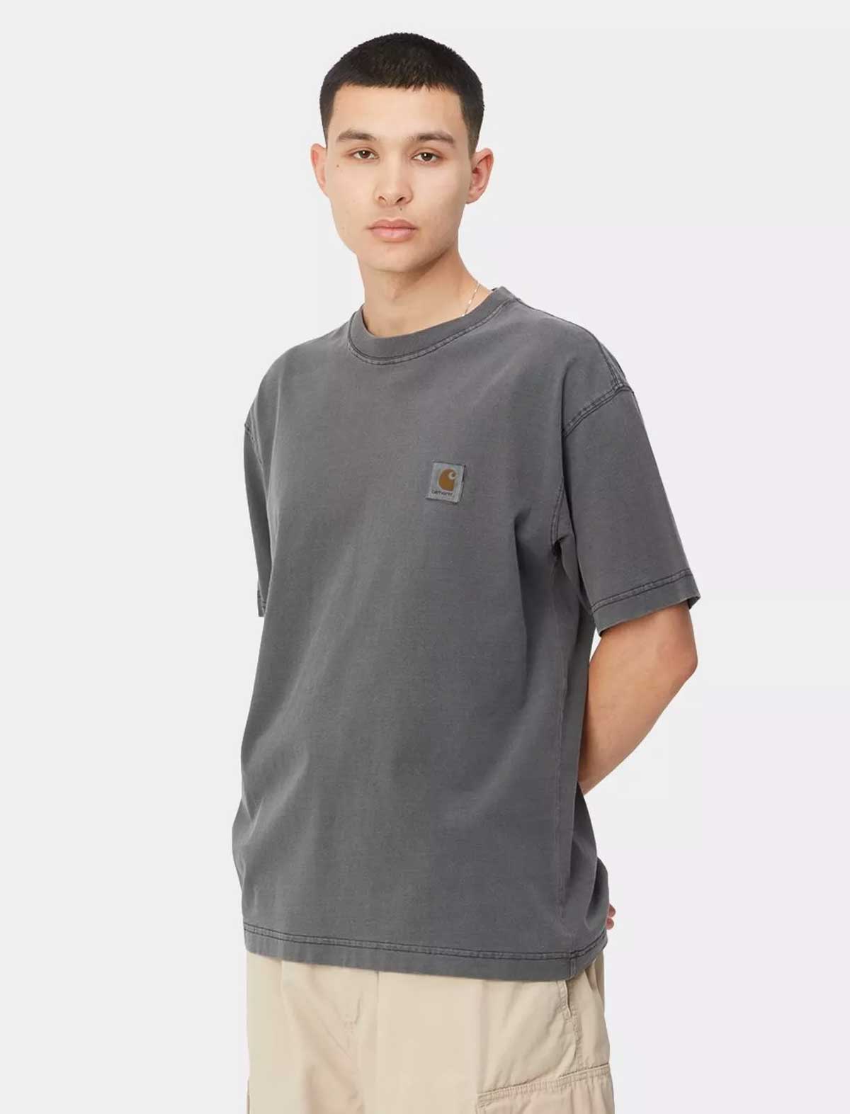 Person wearing a gray t-shirt with a brand logo on a white background