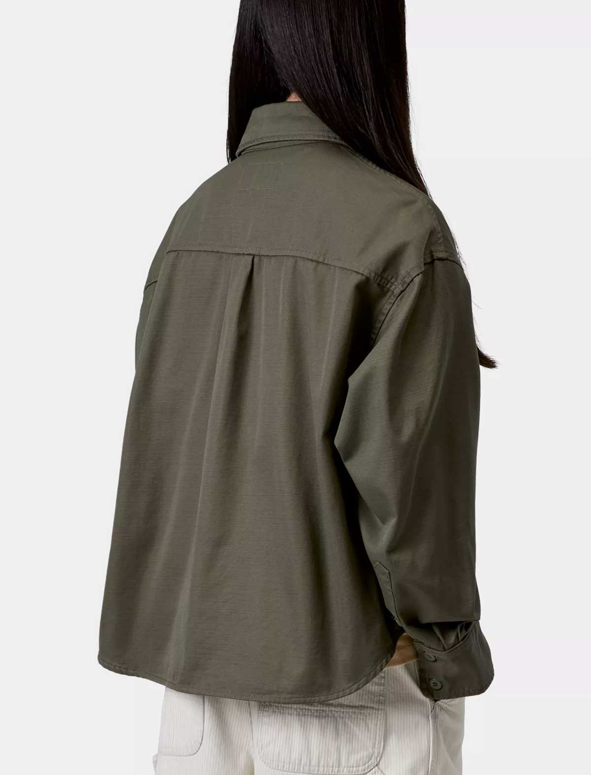 Person wearing a green jacket on a white background