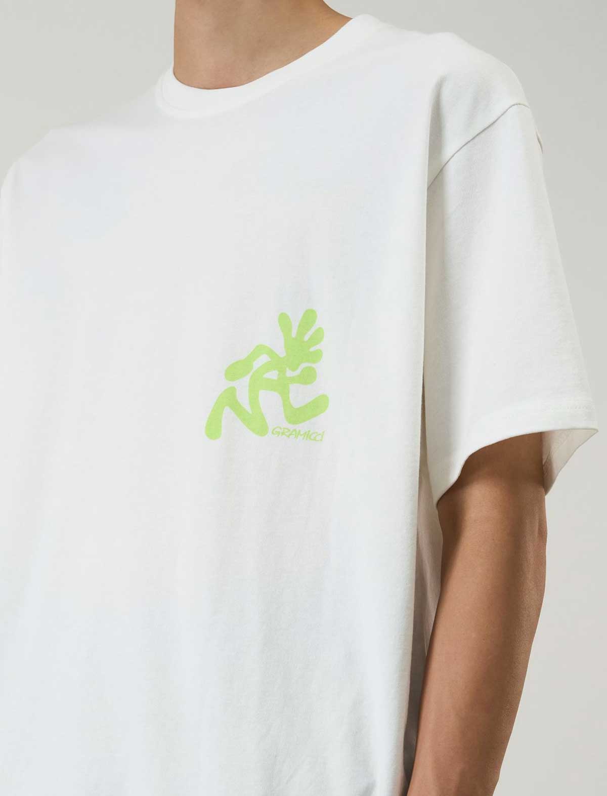 gramicci running manWhite t-shirt with green logo on a plain background