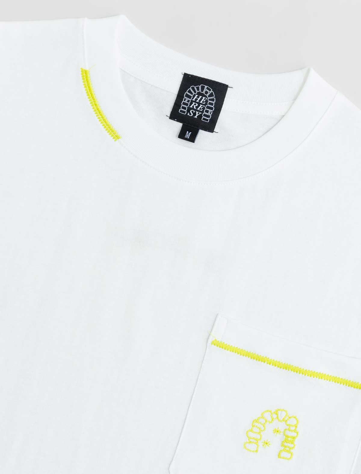 White shirt with yellow accents and a brand label on a light gray background